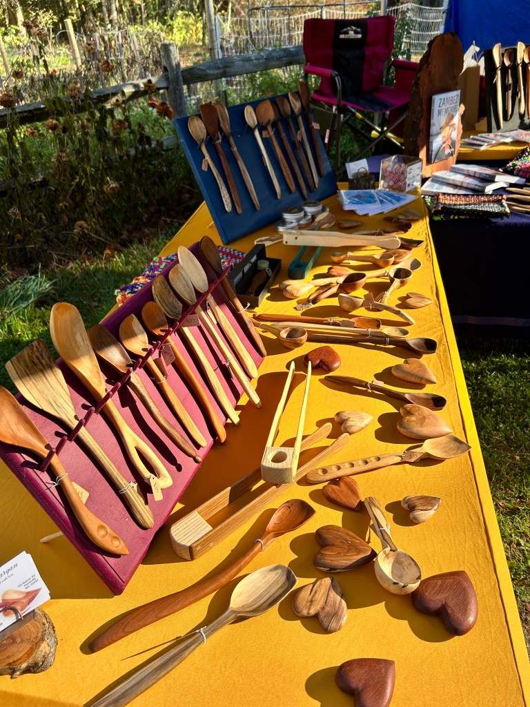 Hand-carved spoons, tongs and wooden hearts fill Phil Gargan’s table
at the 2025 New Hampshire Wool Arts Tour. The Harrisville carver will be at Windfall Farm in
Antrim this weekend.