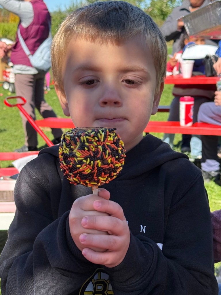 acob Hoisington of West Boylston, Mass., enjoys a candy apple at Washburn's Windy Hill Orchard in Greenville. 