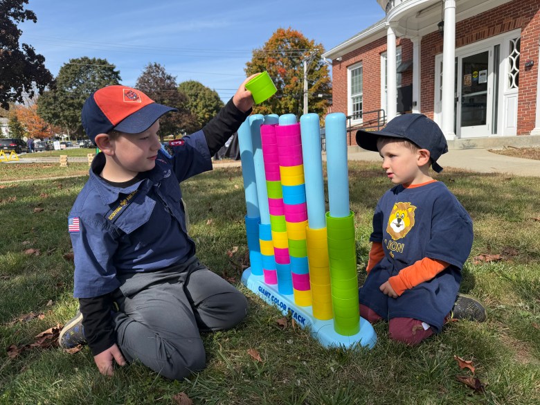 Thomas and Patrick Clarke take a break from selling popcorn for Scout Pack 33 to play a lawn game. 