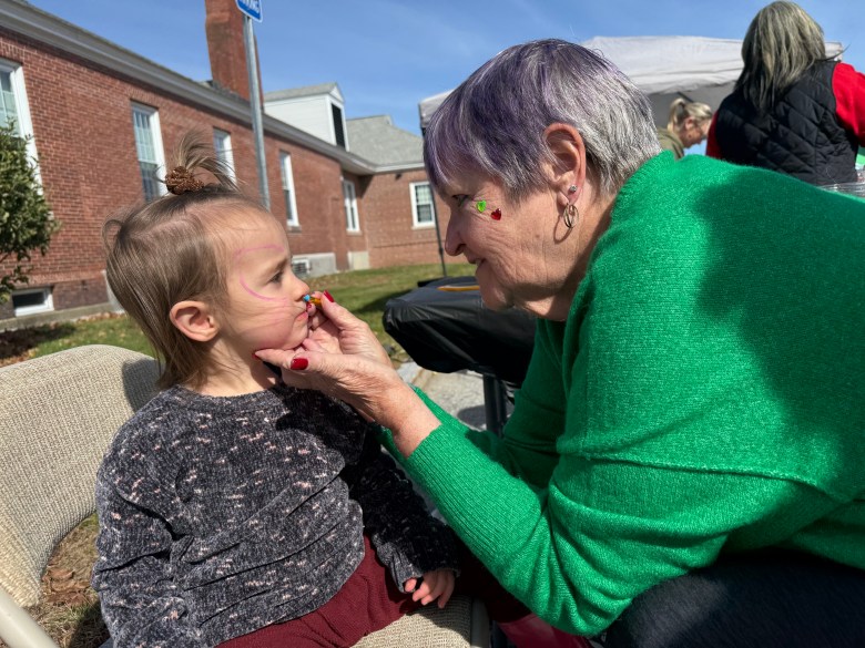 Jane Beauregard of Troy gets a butterfly facepaint from Kathy Batchelder. 