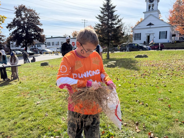Noah Myott, 9, of Jaffrey, builds a head for his scarecrow. 