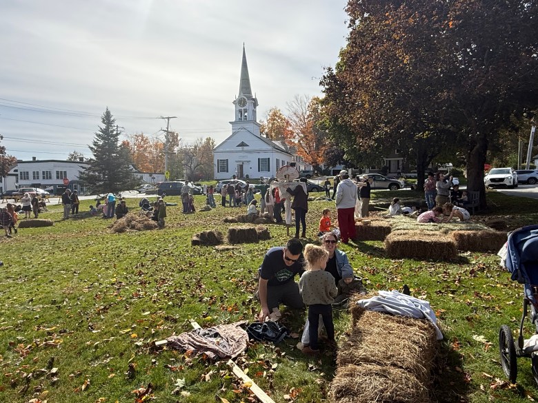 Residents gather on the Jaffrey Public Library lawn to build scarecrows during Fall Fest on Saturday.
