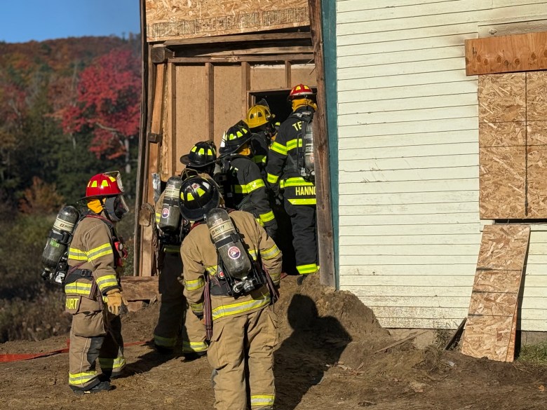 Crews enter the house from the front.