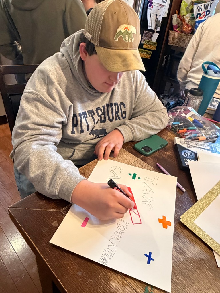 Jake Amadon works on a poster.