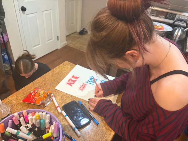 Tea Shuster stencils a poster.