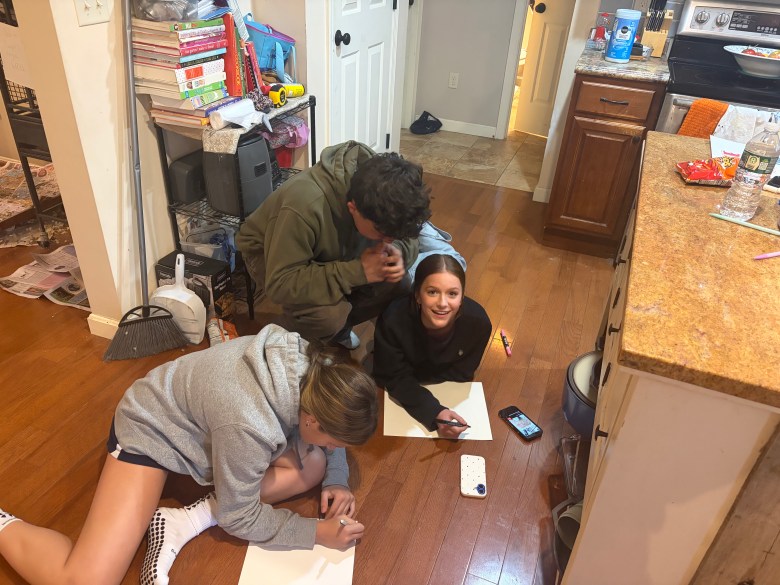 Carter Pierson, Kendra Nicholet and Leah Cote create posters.