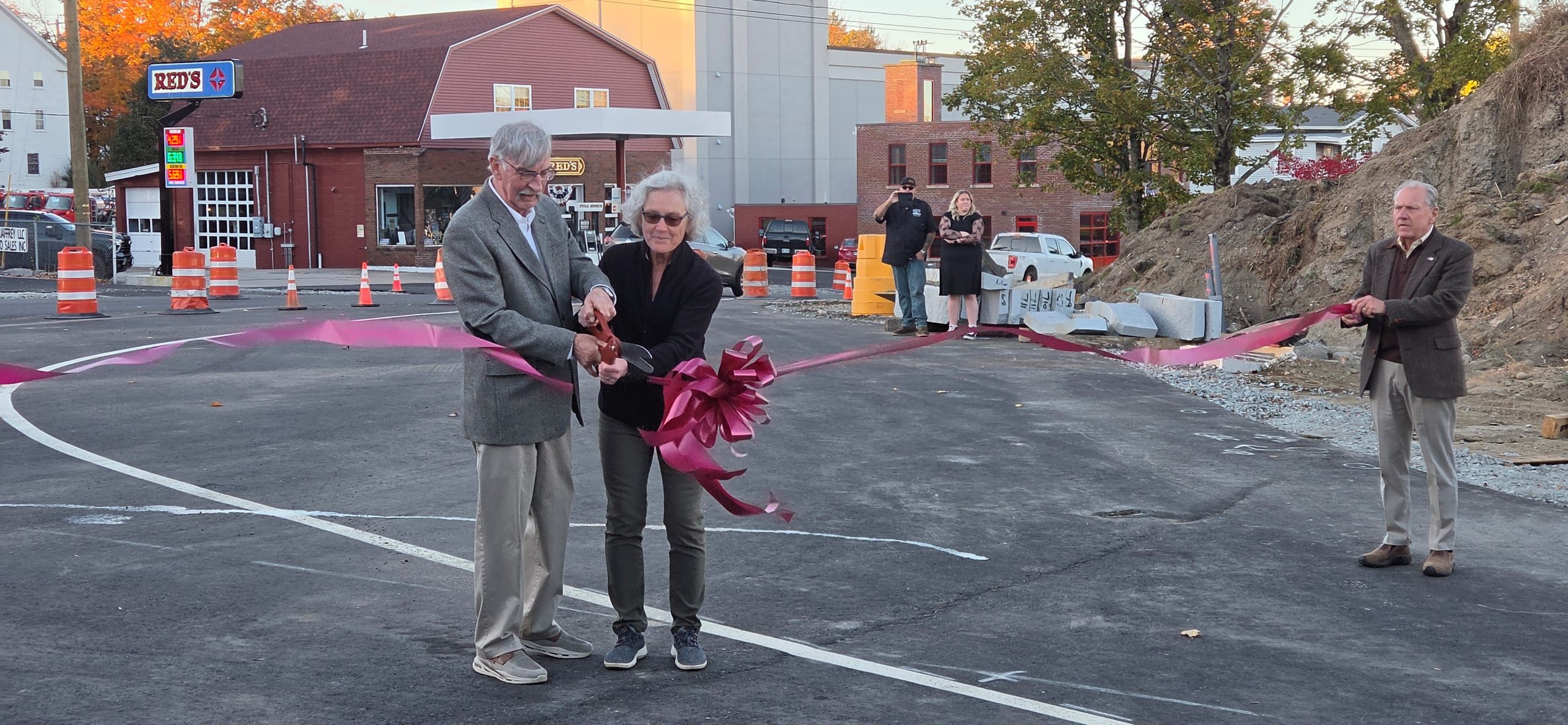 Selectman Frank Sterling and Jaffrey Development Project Coordinator JoAnne Carr and Select Board Chair Charlie Turcotte cut the ribbon to open the bridge.