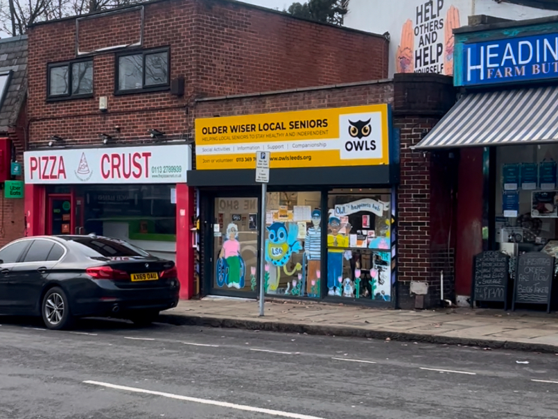 Yellow storefront of OWLS charity