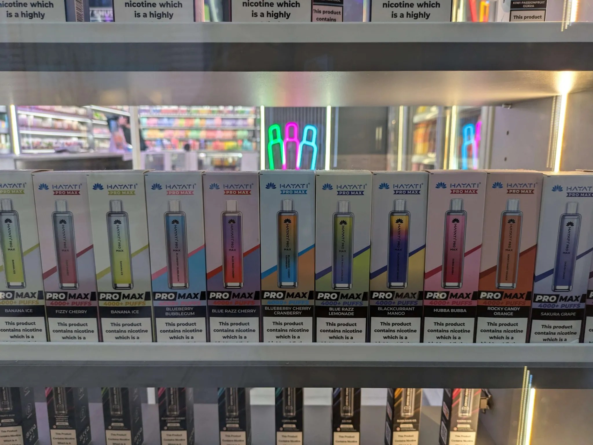 A shop window displays many flavored disposable vapes set to be banned in 2025