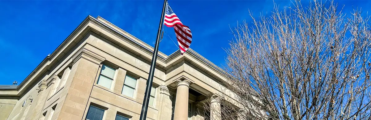 tall government office exterior with American flag