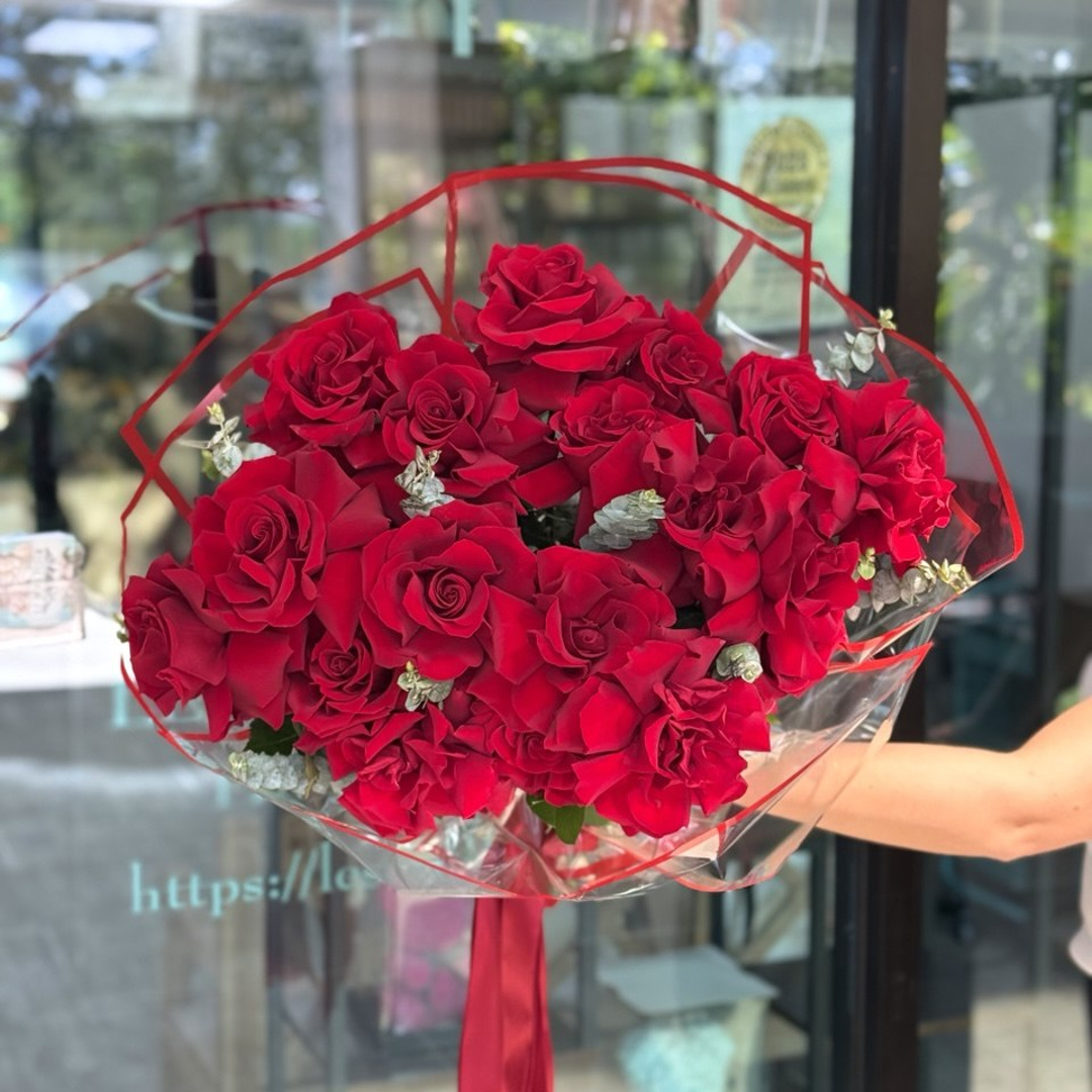 Inverted French red roses bouquet with reflexed petals, eucalyptus, clear wrapping and red ribbon at Le Soul Fleur in Deerfield Beach.