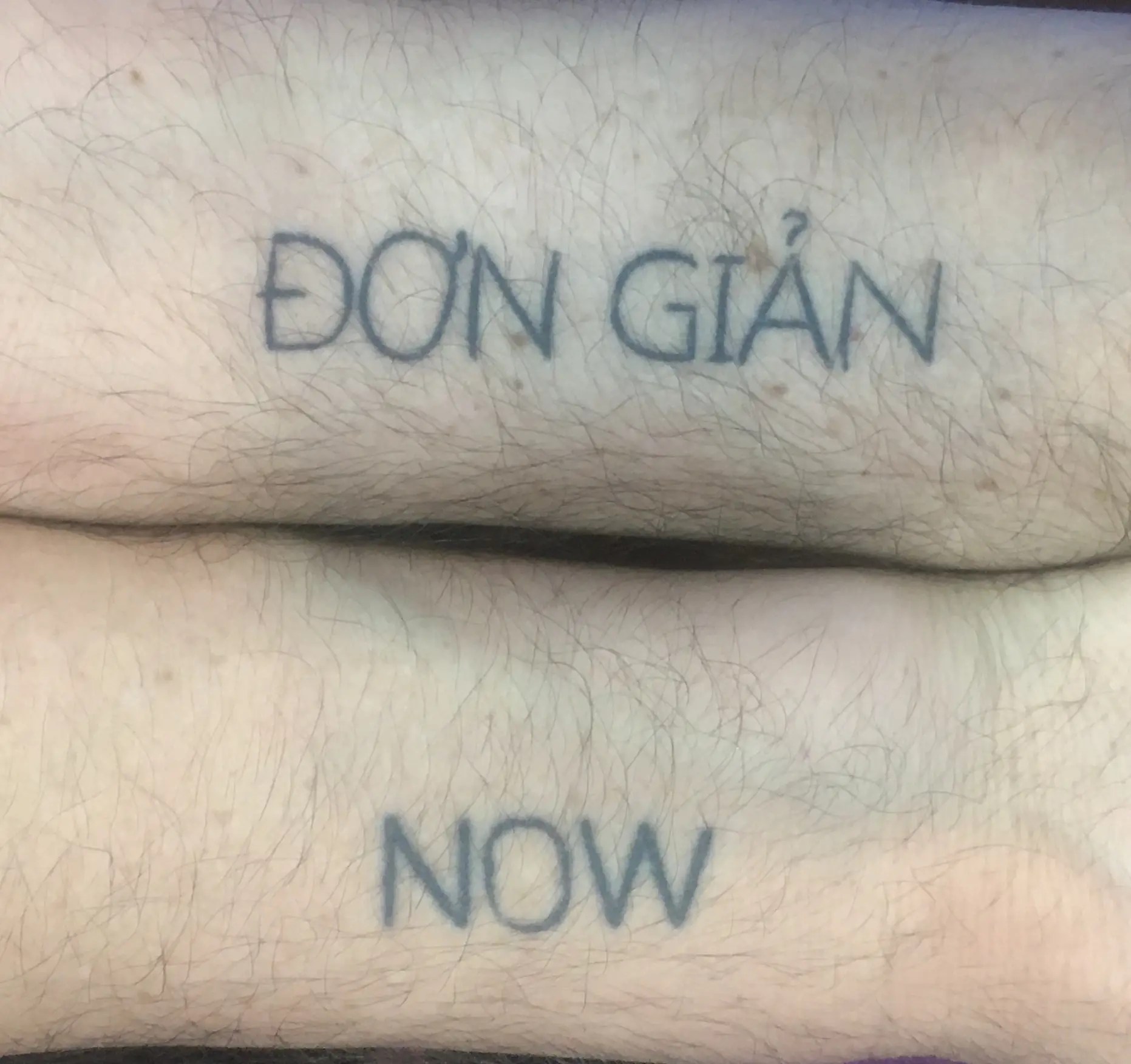 ĐƠN GIẢN has his name tattooed on his right wrist and the word NOW tattooed on his left wrist.