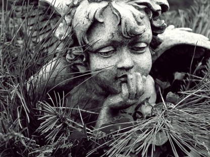 Statue of a child angel pondering