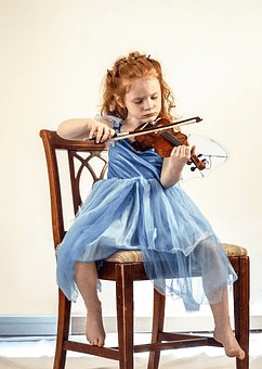 Young girl practicing violin