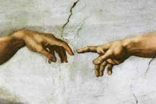 Detail from Michelangelo’s painting, The Creation of Adam, showing God’s hand touching man’s, conferring life.