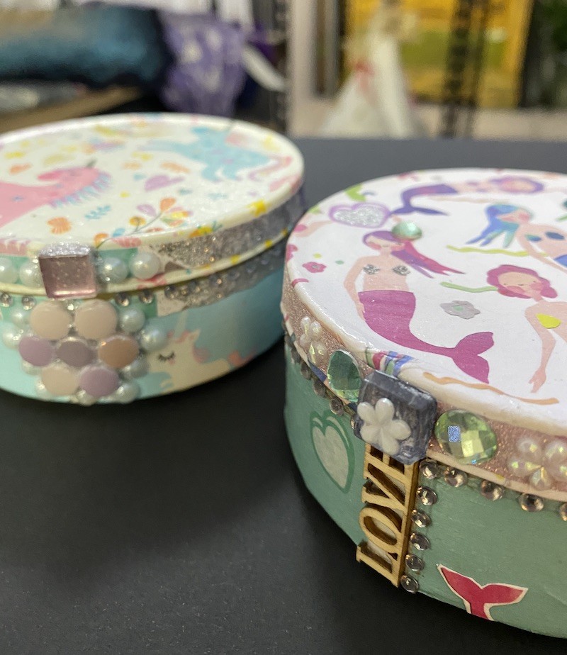 Image of decoupage tin with mermaids and unicorns.