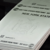 Stack of official New York State vehicle inspection stickers