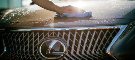 Hand wiping Lexus hood during car wash