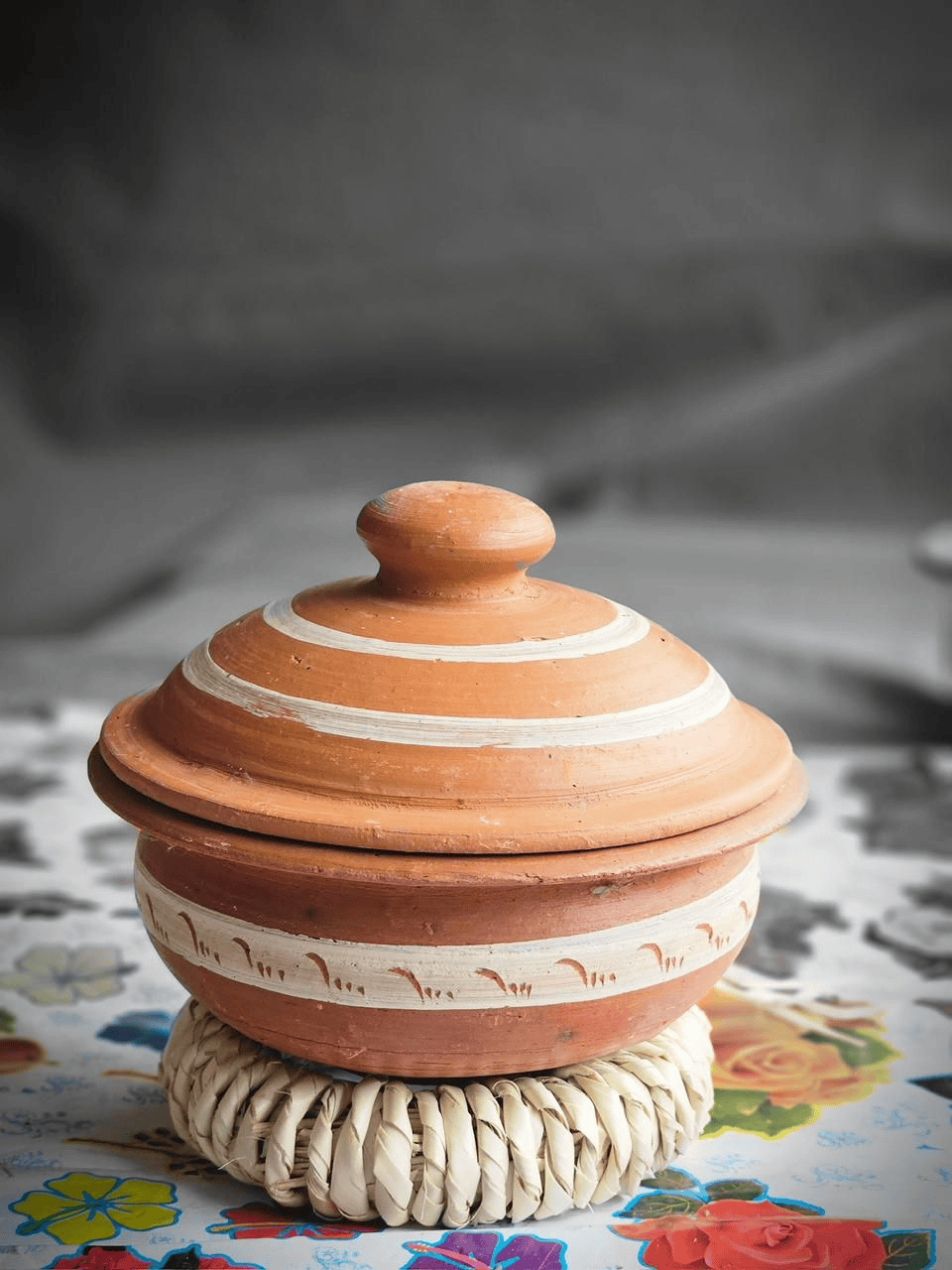 Handmade terracotta or clay cooking pot with a lid.