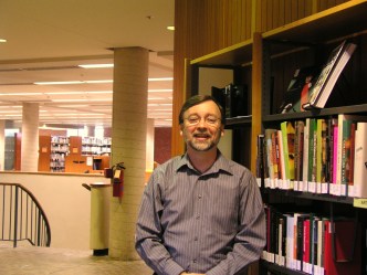 recent photo of Chris in the library stacks