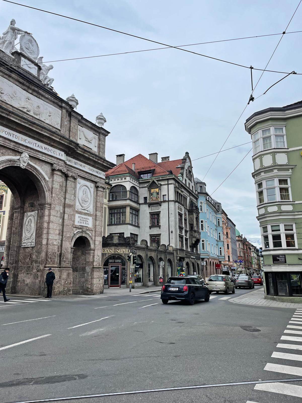 Triumphal Arch in Innsbruck Austria with historic buildings and mountains behind