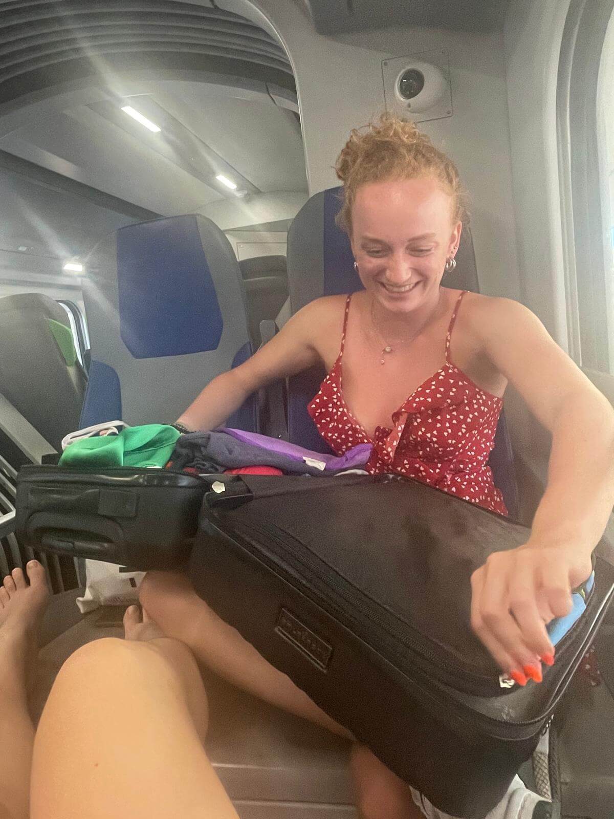 Cousin opening her suitcase on a train in Sicily