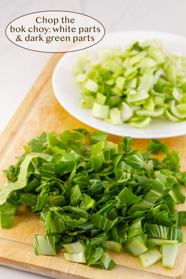 chopped bok choy in two piles, white parts and green parts.