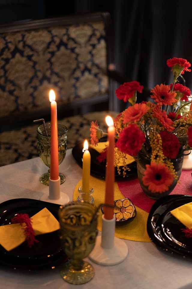 A sophisticated candlelit table setting with vibrant floral centerpiece, perfect for intimate dining.