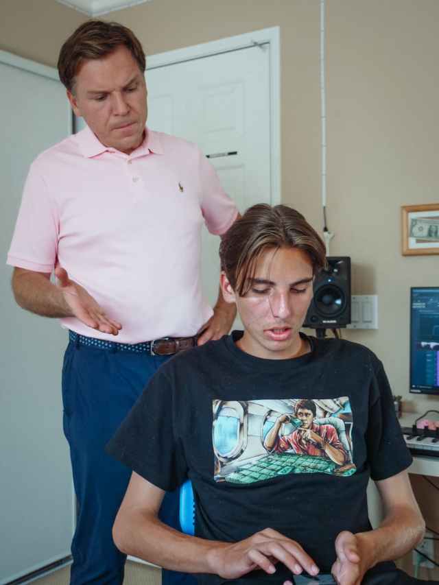 A father confronts his teenager son over smartphone use at home.