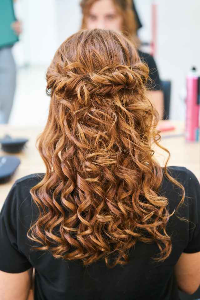 Rear view of elegant curly hairstyle in a hair salon setting.