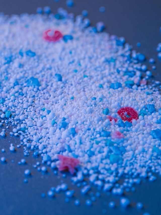 Colored granular substance is scattered on a surface.
