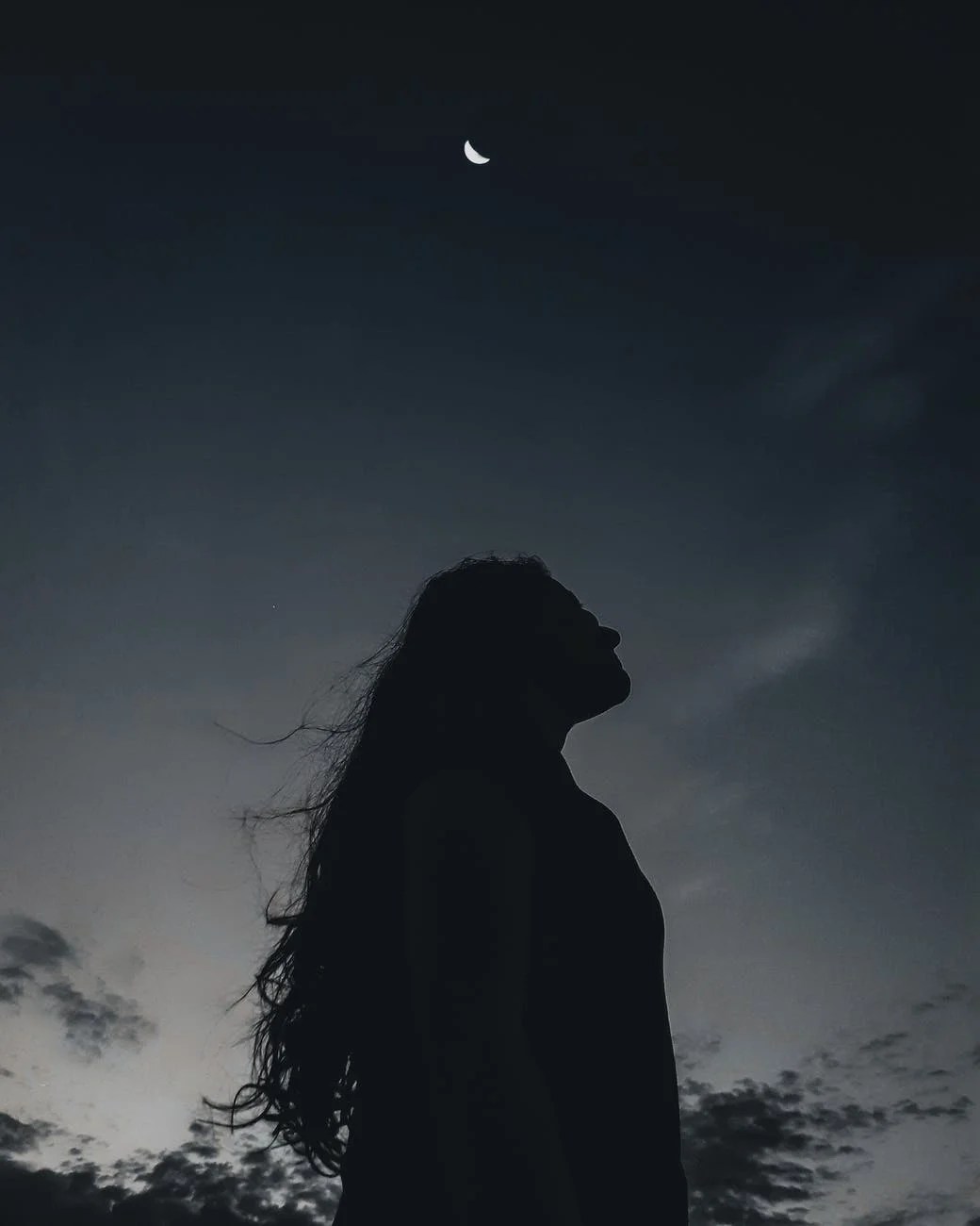 lonely woman under night sky
