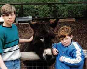 My brother and I posing with a donkey