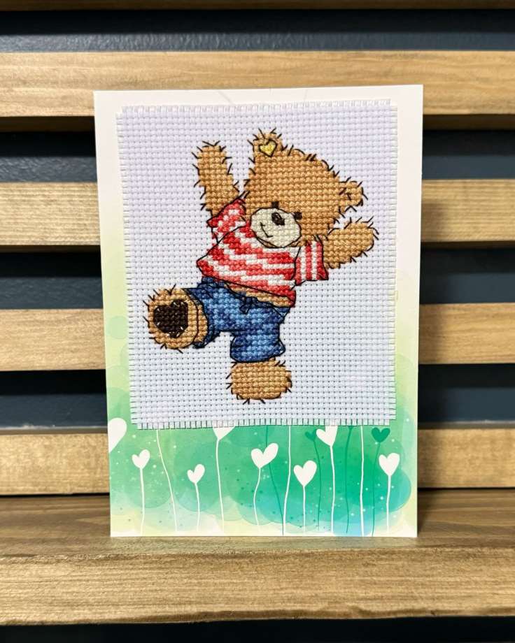 Completed cross-stitch of a teddy bear card