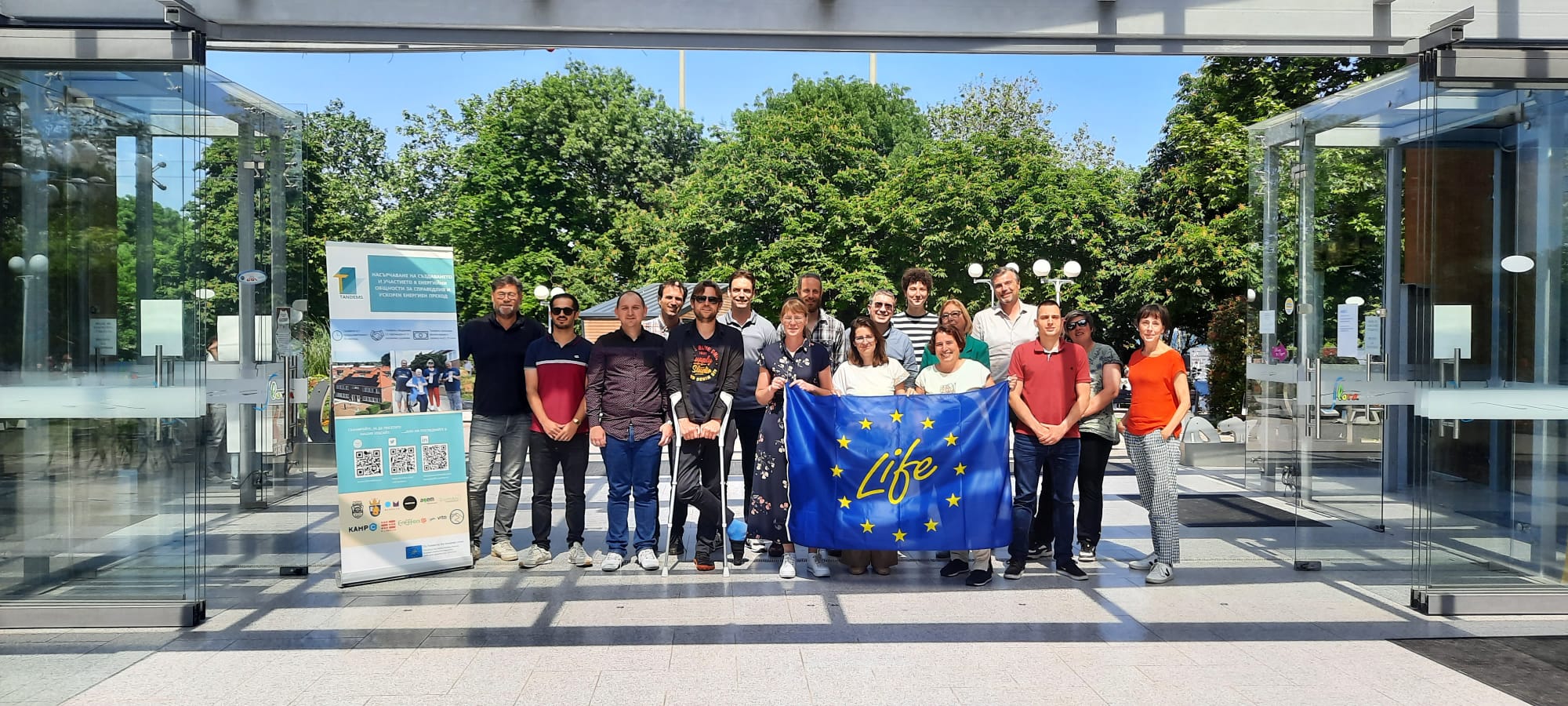 TANDEMS consortium posing for a photo in Burgas with a LifeProgramme flag and a TANDEMS banner.