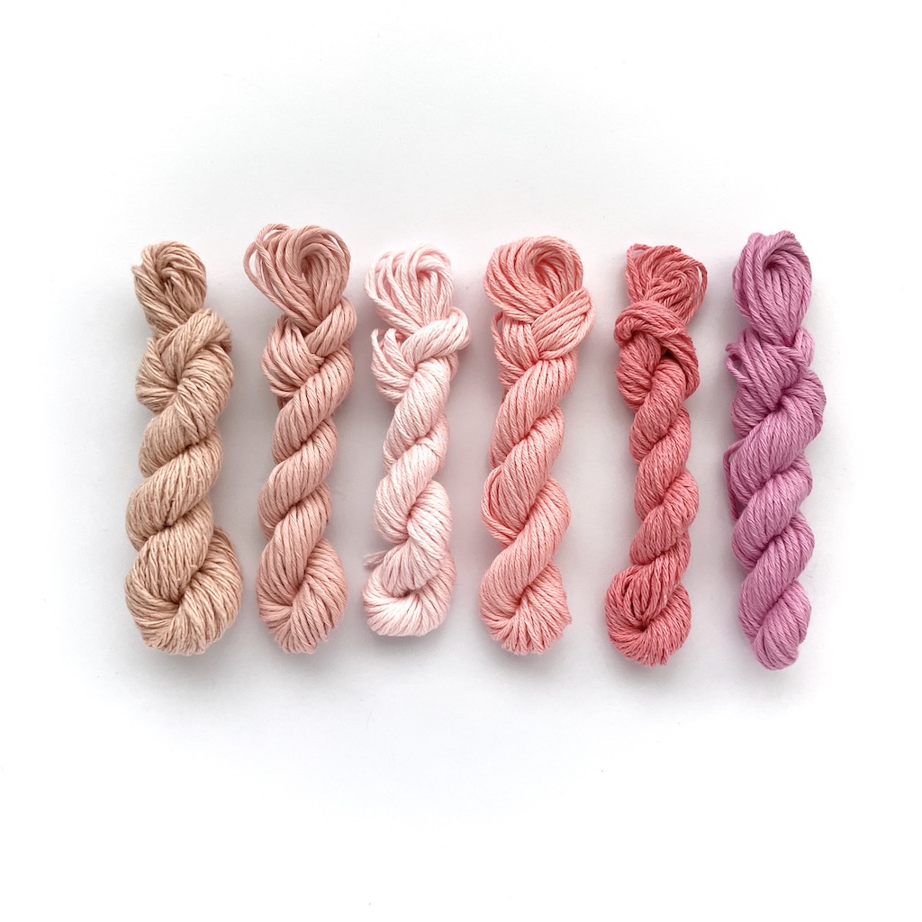 Mini skeins of yarn in different shades of pink