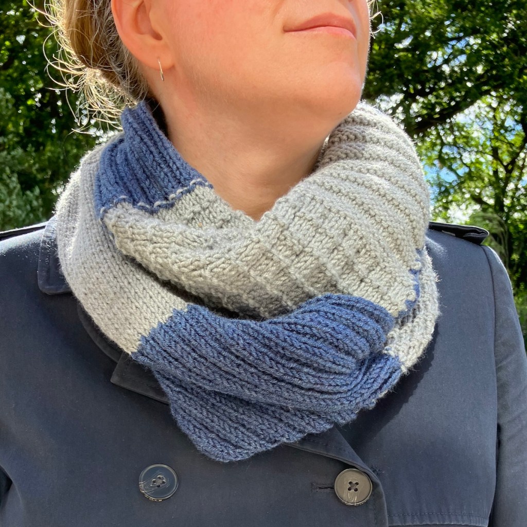 Knitted stitch sampler infinity scarf in grey and blue