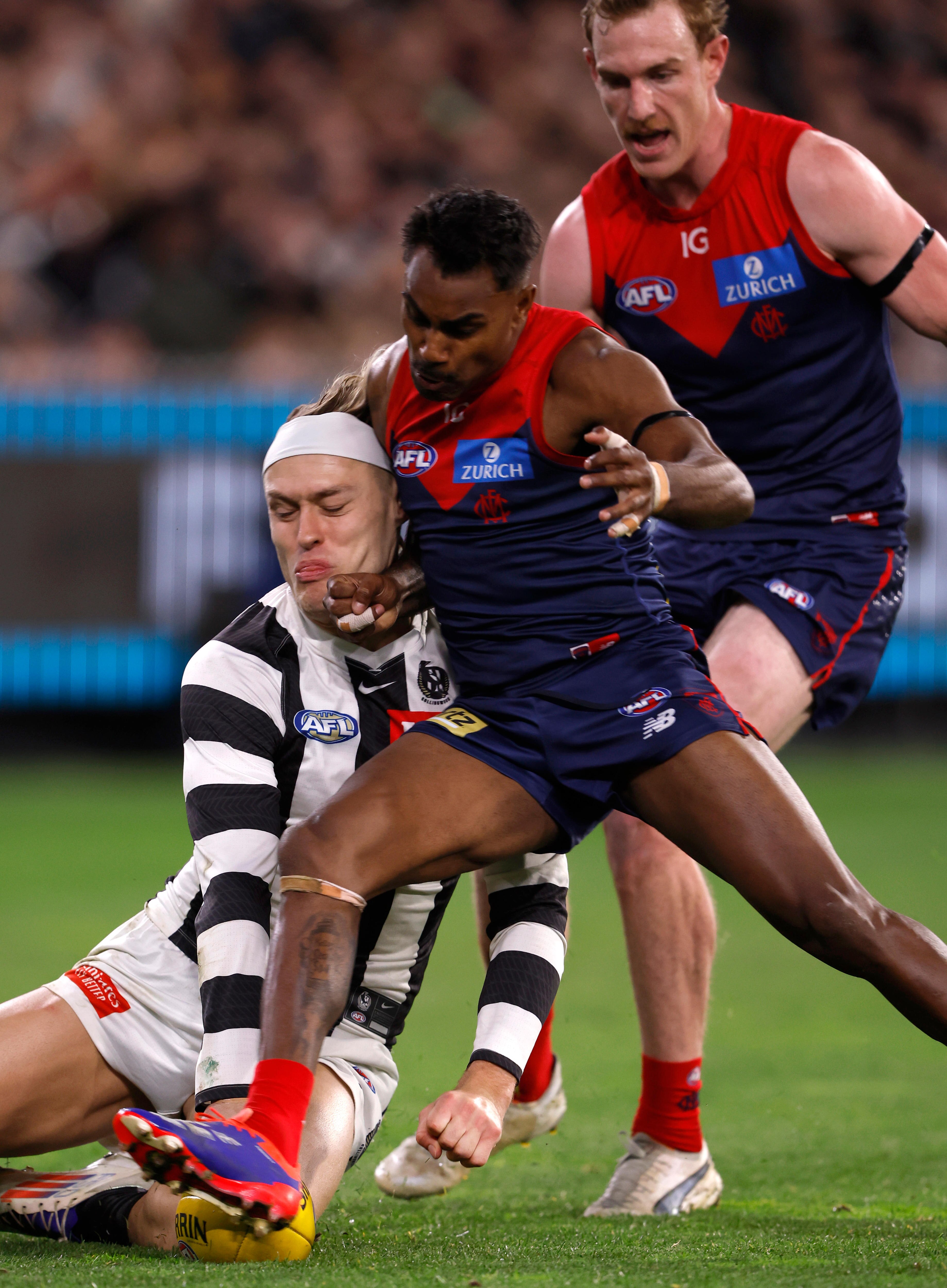 Kysaiah Pickett facing ban after dangerous hit leaves Darcy Moore concussed as Collingwood beats Melbourne amid lightning