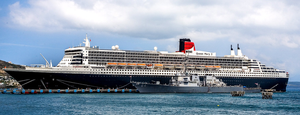 U S Navy Destroyer Docked Next To Cunard S Queen Mary 2