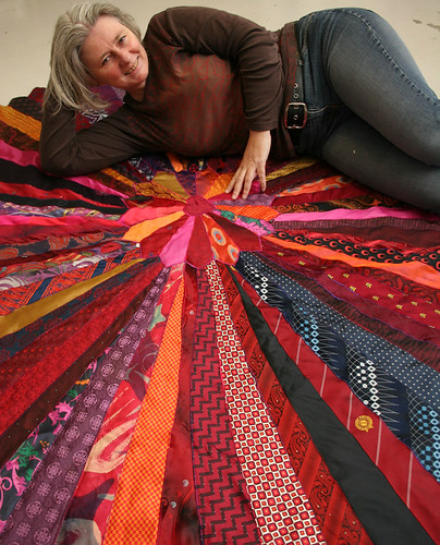 Artisan presenting a handmade rug.