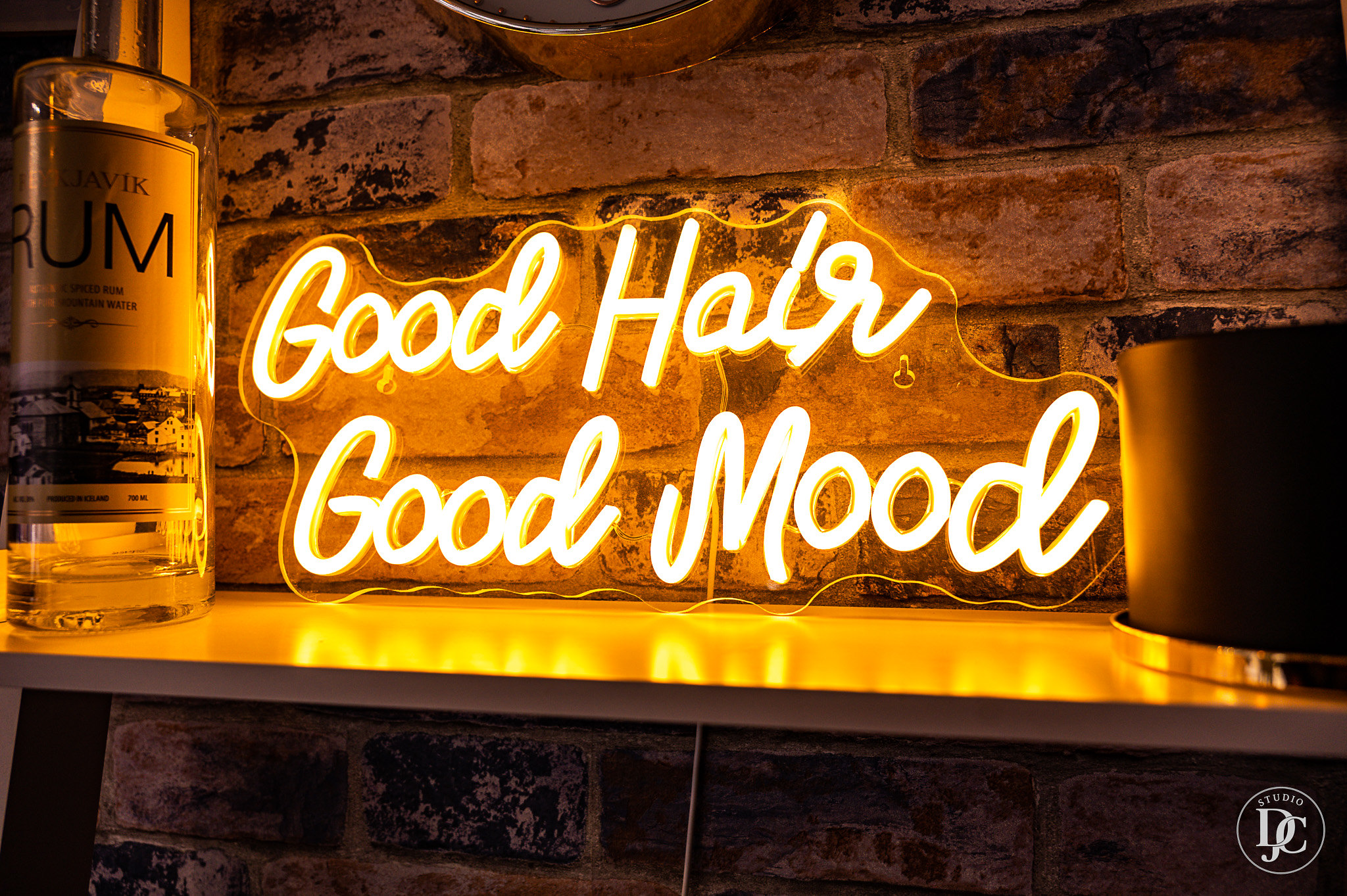 Neon sign reading 'Good hair, good mood' inside Gentlemen’s League