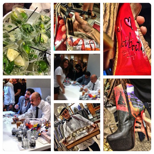 Christian Louboutin signing books at an event, representing his brand presence