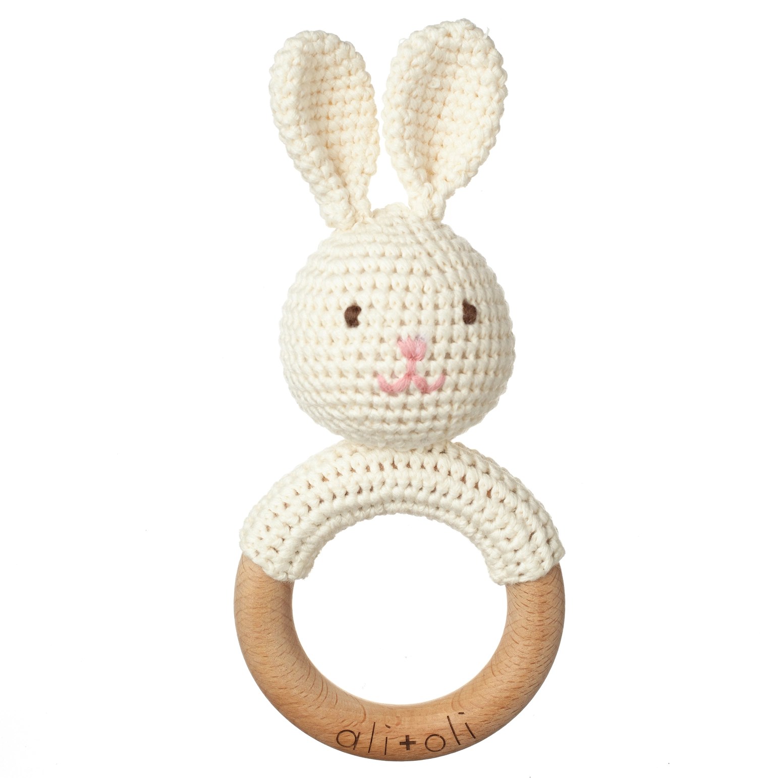 Close-up of a handmade bunny teething toy with a natural beechwood ring and crocheted bunny head.