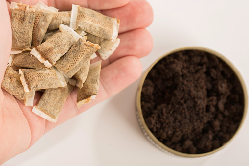 a can of snuff and tobacco pouches