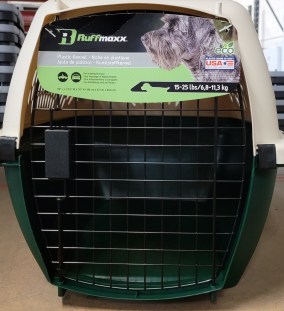 Green and tan plastic dog crate