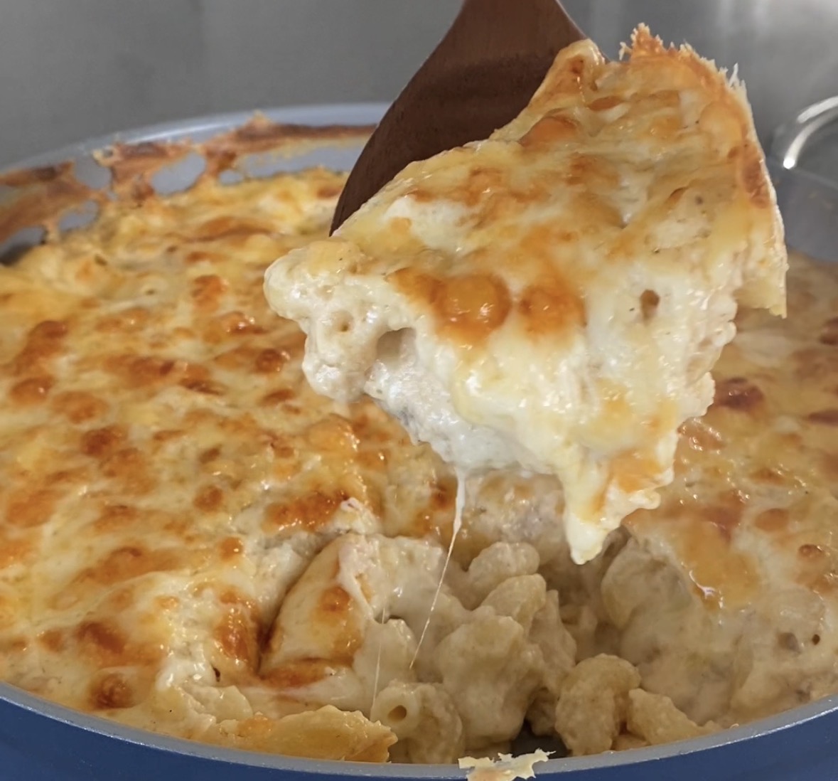 Summer mac and cheese being served out of the skillet