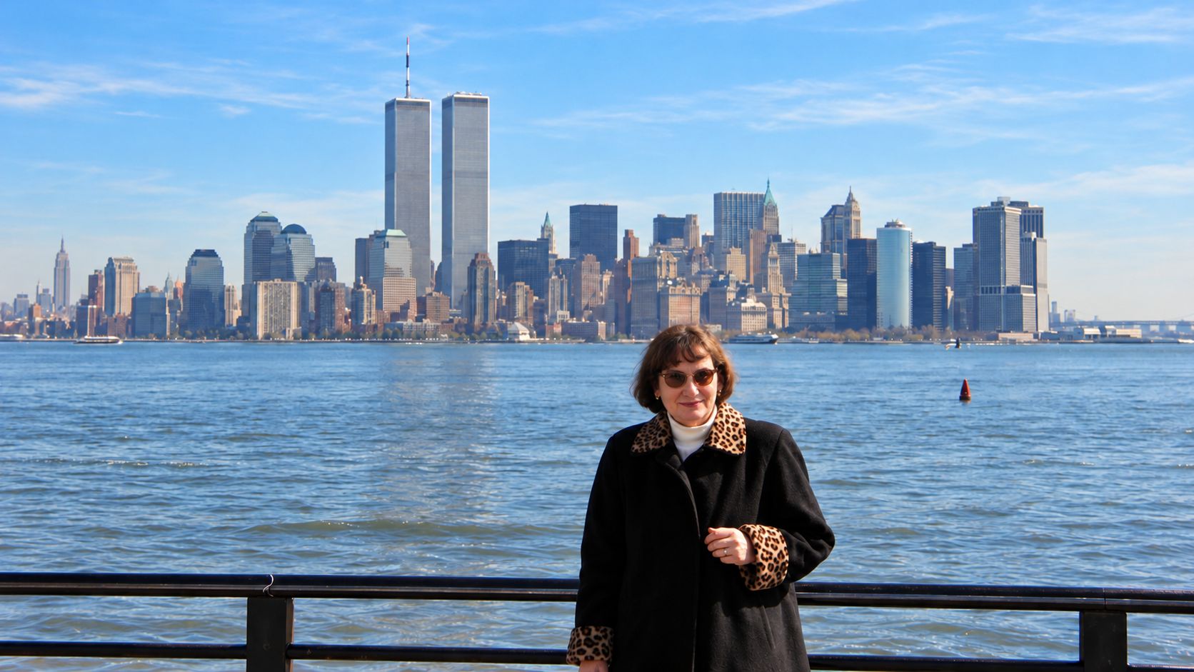 Mutti beside New York Harbour in 1999, with the Twin Towers and Lower Manhattan skyline behind her
