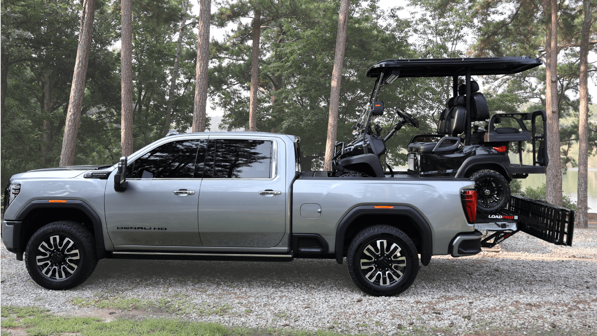Golf cart fully loaded and secured in pickup truck bed with Load Pro ramps folded
