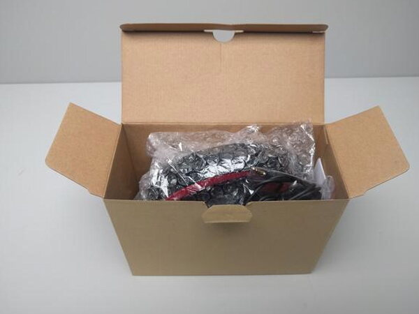 Mpow headphones inside the shipping box