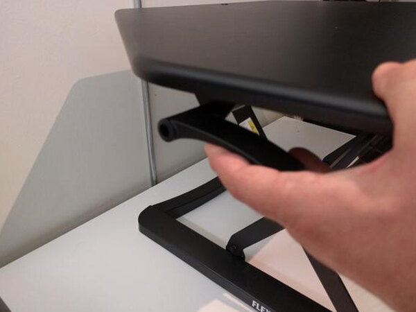 The FlexiSpot desk's X-frame support structure with a FlexiSpot.com label